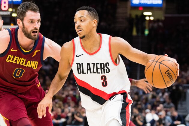 CLEVELAND, OH - JANUARY 2: Kevin Love #0 of the Cleveland Cavaliers tries to stop CJ McCollum #3 of the Portland Trail Blazers during the second half at Quicken Loans Arena on January 2, 2018 in Cleveland, Ohio. The Cavaliers defeated the Trail Blazers 127-110. NOTE TO USER: User expressly acknowledges and agrees that, by downloading and or using this photograph, User is consenting to the terms and conditions of the Getty Images License Agreement. (Photo by Jason Miller/Getty Images)