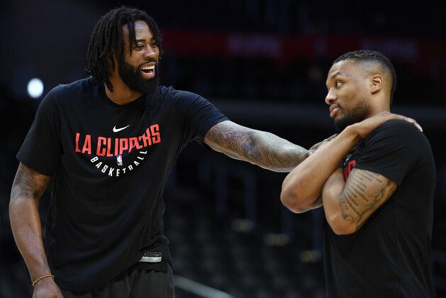 LOS ANGELES, CA - JANUARY 30: DeAndre Jordan #6 of the Los Angeles Clippers and Damian Lillard #0 of the Portland Trail Blazers greet during pre-game warm up prior to the start of a basketball at Staples Center on January 30, 2018 in Los Angeles, California. NOTE TO USER: User expressly acknowledges and agrees that, by downloading and or using this photograph, User is consenting to the terms and conditions of the Getty Images License Agreement. (Photo by Kevork Djansezian/Getty Images)