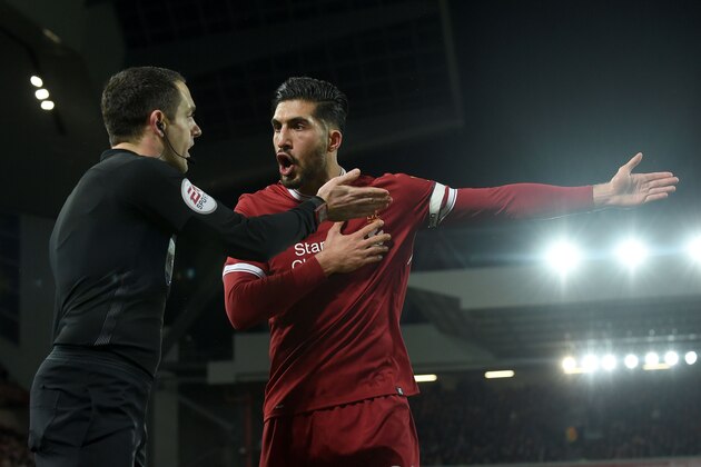 Liverpool's German midfielder Emre Can (R) argues with the linesman after the penalty decision during the English Premier League football match between Liverpool and Tottenham Hotspur at Anfield in Liverpool, north west England on February 4, 2018. / AFP PHOTO / PAUL ELLIS / RESTRICTED TO EDITORIAL USE. No use with unauthorized audio, video, data, fixture lists, club/league logos or 'live' services. Online in-match use limited to 75 images, no video emulation. No use in betting, games or single club/league/player publications.  /         (Photo credit should read PAUL ELLIS/AFP/Getty Images)
