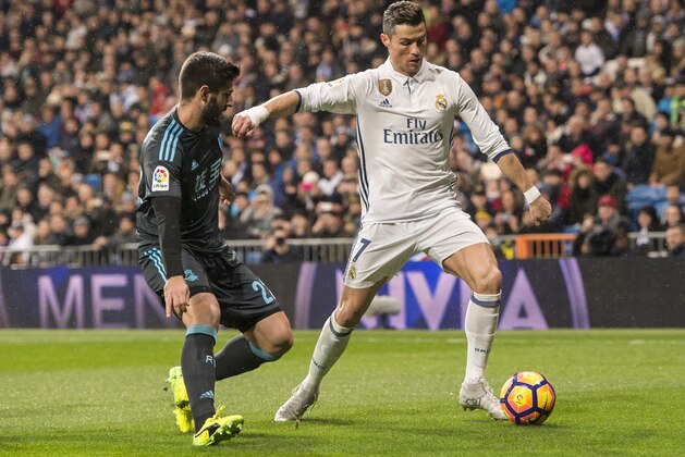 MADRID, SPAIN - JANUARY 29: Cristiano Ronaldo (r) of Real Madrid battles for the ball with Raul Rodriguez Navas of Real Sociedad during their La Liga match between Real Madrid and Real Sociedad at the Santiago Bernabeu Stadium on 29 January 2017 in Madrid, Spain. (Photo by Power Sport Images/Getty Images)