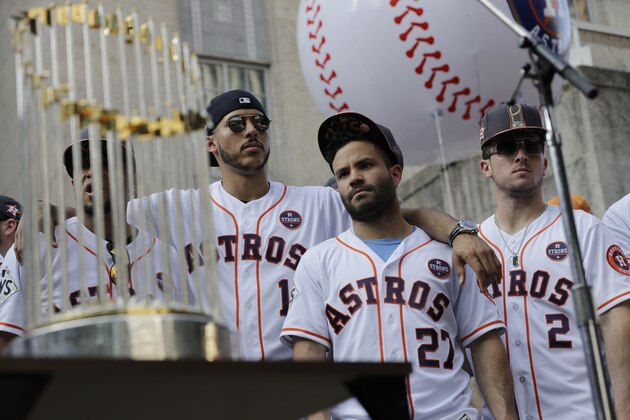 Houston Astros' Carlos Correa (1), Jose Altuve (27), and Alex Bregman (2) celebrate during a rally honoring the World Series baseball champions Friday, Nov. 3, 2017, in Houston. (AP Photo/David J. Phillip)