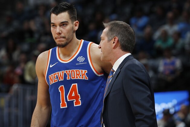 New York Knicks head coach Jeff Hornacek, right, confers with center Willy Hernangomez, of Spain, as he waits to check in against the Denver Nuggets in the first half of an NBA basketball game Thursday, Jan. 25, 2018, in Denver. (AP Photo/David Zalubowski)