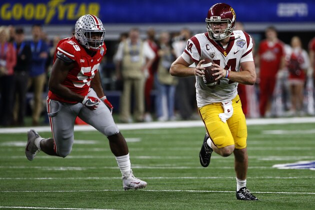 ARLINGTON, TX - DECEMBER 29: Sam Darnold #14 of the USC Trojans runs from Tyquan Lewis #59 of the Ohio State Buckeyes in the second half of the 82nd Goodyear Cotton Bowl Classic between USC and Ohio State at AT&T Stadium on December 29, 2017 in Arlington, Texas. Ohio State won 24-7.  (Photo by Ron Jenkins/Getty Images)