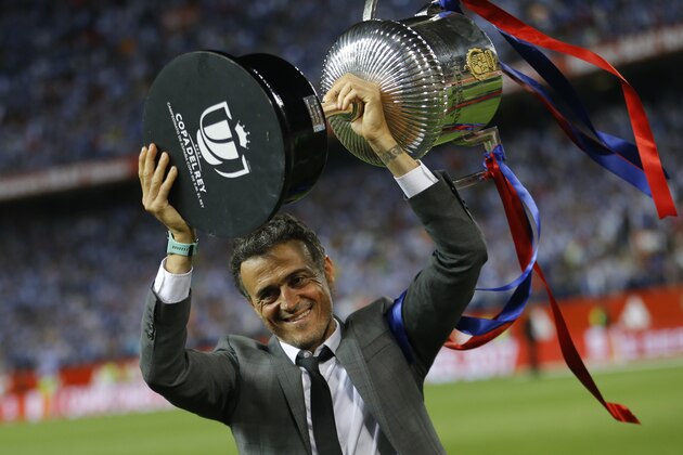 Barcelona's head coach Luis Enrique lifts the trophy after the Copa del Rey final soccer match between Barcelona and Alaves at the Vicente Calderon stadium in Madrid, Spain, Saturday, May 27, 2017. Barcelona won the match 3-1. (AP Photo/Francisco Seco)