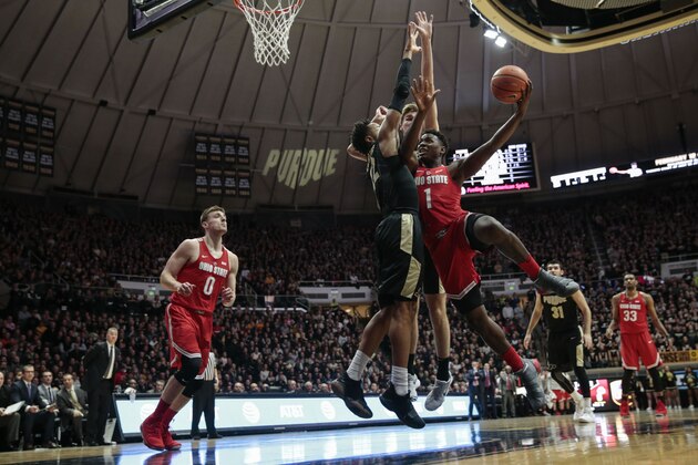 Ohio State forward Jae'Sean Tate, right, tries to shoot around Purdue defenders Vincent Edwards, left, and Matt Haarms during the first half of an NCAA college basketball game in West Lafayette, Ind., Wednesday, Feb. 7, 2018. (AP Photo/AJ Mast)