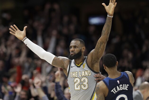 Cleveland Cavaliers' LeBron James, left, celebrates after making the game-winning basket in overtime in an NBA basketball game against the Minnesota Timberwolves, Wednesday, Feb. 7, 2018, in Cleveland. The Cavaliers won 140-138 in overtime. (AP Photo/Tony Dejak)