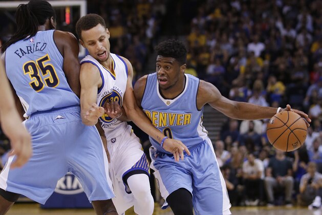 Denver Nuggets' Emmanuel Mudiay (0) dribbles around Golden State Warriors' Stephen Curry on a screen from Kenneth Faried (35) during the first half of an NBA preseason basketball game Tuesday, Oct. 13, 2015, in Oakland, Calif. (AP Photo/Marcio Jose Sanchez)