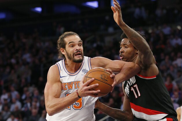 New York Knicks center Joakim Noah (13), making his season debut after a suspension for performance enhancing drugs, goes up against Portland Trail Blazers forward Ed Davis (17) during the first half of an NBA basketball game in New York, Monday, Nov. 27, 2017. (AP Photo/Kathy Willens)