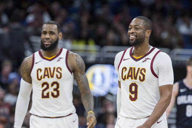 Friends and teammates Cleveland Cavaliers forward LeBron James (23) and Cleveland Cavaliers guard Dwyane Wade (9) walk the court during the second half of an NBA basketball game against the Orlando Magic in Orlando, Fla., Saturday, Jan. 6, 2018. James and Wade were also teammates on the Miami Heat. (AP Photo/Willie J. Allen Jr.)