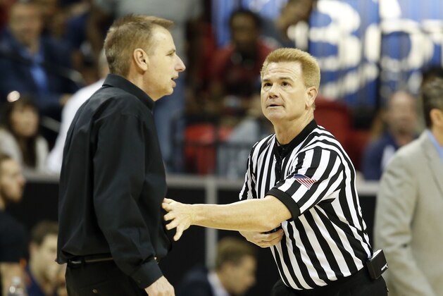 Official Larry Spaulding holds back Colorado State coach Larry Eustache before calling a technical foul on him during the second half of the team's NCAA college basketball game against Nevada in the Mountain West Conference tournament championship Saturday, March 11, 2017, in Las Vegas. Nevada won 79-71. (AP Photo/Isaac Brekken)