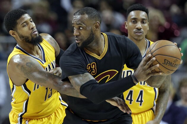 Cleveland Cavaliers' LeBron James (23) tries to get past Indiana Pacers' Paul George (13) in the second half of an NBA basketball game, Wednesday, Feb. 15, 2017, in Cleveland. The Cavaliers won 113-104. (AP Photo/Tony Dejak)