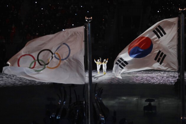 The Olympic torch is carried into the stadium during the opening ceremony of the 2018 Winter Olympics in Pyeongchang, South Korea, Friday, Feb. 9, 2018. (AP Photo/Matthias Schrader)