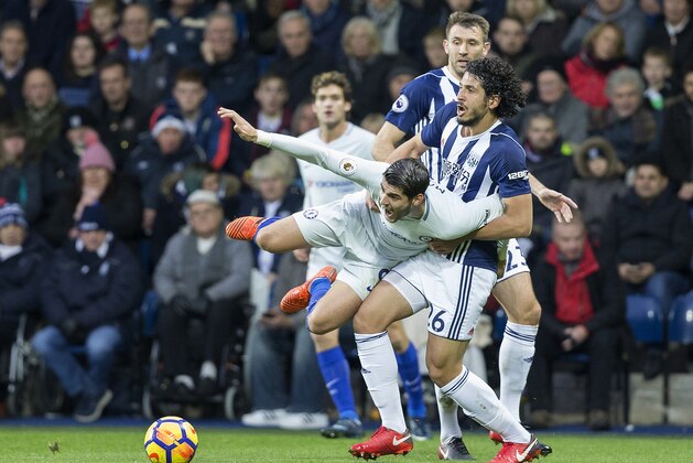 TOPSHOT - West Bromwich Albion's Egyptian defender Ahmed Hegazy (R) vies with Chelsea's Spanish striker Alvaro Morata (C) during the English Premier League football match between West Bromwich Albion and Chelsea at The Hawthorns stadium in West Bromwich, central England, on November 18, 2017.
 / AFP PHOTO / Roland Harrison / RESTRICTED TO EDITORIAL USE. No use with unauthorized audio, video, data, fixture lists, club/league logos or 'live' services. Online in-match use limited to 75 images, no video emulation. No use in betting, games or single club/league/player publications.  /         (Photo credit should read ROLAND HARRISON/AFP/Getty Images)