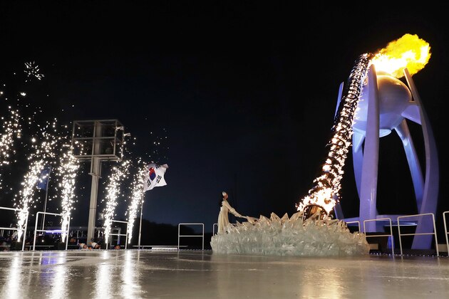 South Korean Olympic figure skating champion Yuna Kim lights the Olympic flame during the opening ceremony of the 2018 Winter Olympics in Pyeongchang, South Korea, Friday, Feb. 9, 2018. (AP Photo/David J. Phillip,Pool)