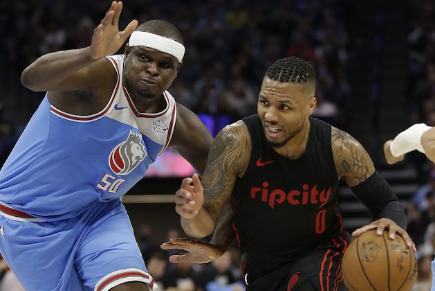 Portland Trail Blazers guard Damian Lillard, right, drives against Sacramento Kings forward Zach Randolph during the second half of an NBA basketball game Friday, Feb. 9, 2018, in Sacramento, Calif. The Trail Blazers won 118-100. (AP Photo/Rich Pedroncelli)