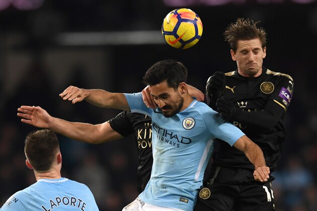Manchester City's German midfielder Ilkay Gundogan (C) vies with Leicester City's Portuguese midfielder Adrien Silva (R) during the English Premier League football match between Manchester City and Leicester City at the Etihad Stadium in Manchester, north west England, on February 10, 2018. / AFP PHOTO / Paul ELLIS / RESTRICTED TO EDITORIAL USE. No use with unauthorized audio, video, data, fixture lists, club/league logos or 'live' services. Online in-match use limited to 75 images, no video emulation. No use in betting, games or single club/league/player publications.  /         (Photo credit should read PAUL ELLIS/AFP/Getty Images)