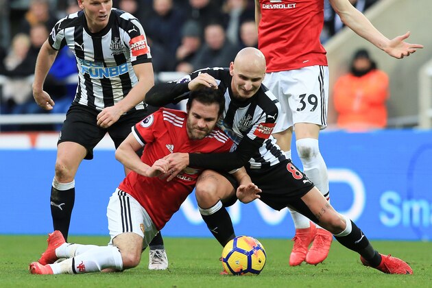 Newcastle United's English midfielder Jonjo Shelvey (R) tangles with Manchester United's Spanish midfielder Juan Mata (L) during the English Premier League football match between Newcastle United and Manchester United at St James' Park in Newcastle-upon-Tyne, north east England on February 11, 2018. / AFP PHOTO / Lindsey PARNABY / RESTRICTED TO EDITORIAL USE. No use with unauthorized audio, video, data, fixture lists, club/league logos or 'live' services. Online in-match use limited to 75 images, no video emulation. No use in betting, games or single club/league/player publications.  /         (Photo credit should read LINDSEY PARNABY/AFP/Getty Images)