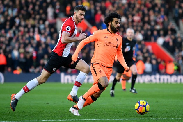 SOUTHAMPTON, ENGLAND - FEBRUARY 11:  Mohamed Salah of Liverpool runs with the ball under pressure from Wesley Hoedt of Southampton during the Premier League match between Southampton and Liverpool at St Mary's Stadium on February 11, 2018 in Southampton, England.  (Photo by Michael Regan/Getty Images)
