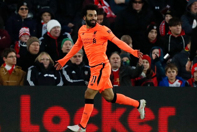 Liverpool's Egyptian midfielder Mohamed Salah celebrates scoring their second goal during the English Premier League football match between Southampton and Liverpool at St Mary's Stadium in Southampton, southern England on February 11, 2018. / AFP PHOTO / Adrian DENNIS / RESTRICTED TO EDITORIAL USE. No use with unauthorized audio, video, data, fixture lists, club/league logos or 'live' services. Online in-match use limited to 75 images, no video emulation. No use in betting, games or single club/league/player publications.  /         (Photo credit should read ADRIAN DENNIS/AFP/Getty Images)