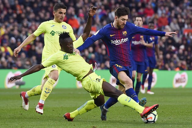 Getafe's Togolese defender Dakonam Djene (2L) vies with Barcelona's Argentinian forward Lionel Messi during the Spanish league football match between FC Barcelona and Getafe CF at the Camp Nou stadium in Barcelona on February 11, 2018. / AFP PHOTO / Josep LAGO        (Photo credit should read JOSEP LAGO/AFP/Getty Images)