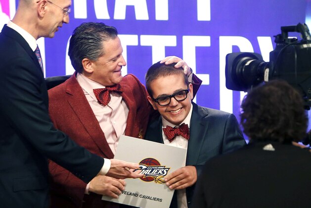 Cleveland Cavaliers owner Dan Gilbert congratulates his son Nick Gilbert after the team won the NBA basketball draft lottery, Tuesday, May 21, 2013 in New York. (AP Photo/Jason DeCrow)