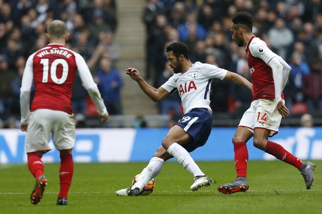 Tottenham Hotspur's Belgian midfielder Mousa Dembele (C) weaves between Arsenal's Gabonese striker Pierre-Emerick Aubameyang (R) and Arsenal's English midfielder Jack Wilshere (L) during the English Premier League football match between Tottenham Hotspur and Arsenal at Wembley Stadium in London, on February 10, 2018. / AFP PHOTO / IKIMAGES / Ian KINGTON / RESTRICTED TO EDITORIAL USE. No use with unauthorized audio, video, data, fixture lists, club/league logos or 'live' services. Online in-match use limited to 45 images, no video emulation. No use in betting, games or single club/league/player publications.  /         (Photo credit should read IAN KINGTON/AFP/Getty Images)