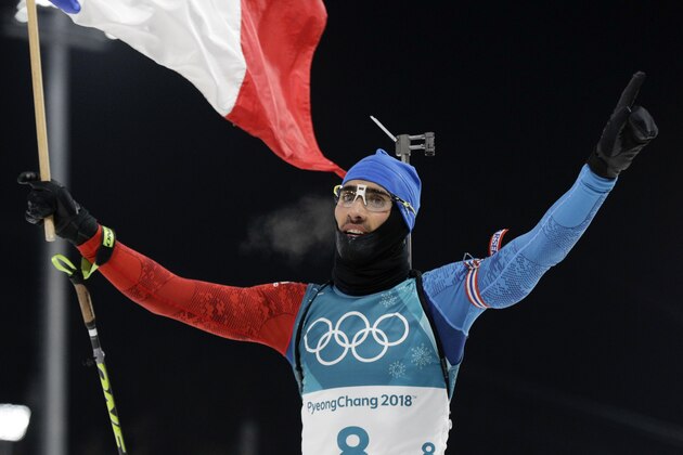 Martin Fourcade, of France, waves the French flag as he celebrates his gold medal finish in the men's 12.5-kilometer biathlon pursuit at the 2018 Winter Olympics in Pyeongchang, South Korea, Monday, Feb. 12, 2018. (AP Photo/Gregorio Borgia)