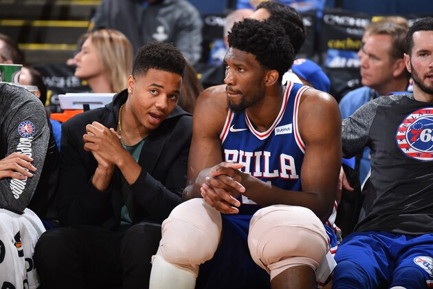 OAKLAND, CA - NOVEMBER 11:  Markelle Fultz #20 and Joel Embiid #21 of the Philadelphia 76ers look on from the sideline during the game against the Golden State Warriors on November 11, 2017 at ORACLE Arena in Oakland, California. NOTE TO USER: User expressly acknowledges and agrees that, by downloading and or using this photograph, user is consenting to the terms and conditions of Getty Images License Agreement. Mandatory Copyright Notice: Copyright 2017 NBAE (Photo by Andrew D. Bernstein/NBAE via Getty Images)