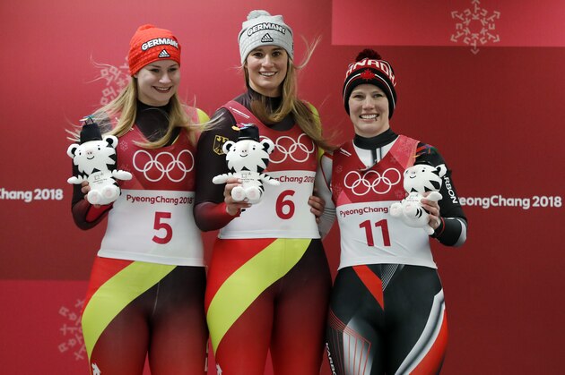 From left to right, silver medalist Dajana Eitberger of Germany, gold medalist Natalie Geisenberger of Germany, and bronze medalist Alex Gough of Canada, celebrate during the winners ceremony after the women's luge final at the 2018 Winter Olympics in Pyeongchang, South Korea, Tuesday, Feb. 13, 2018. (AP Photo/Andy Wong)