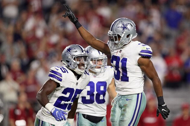 GLENDALE, AZ - SEPTEMBER 25:  Free safety Byron Jones #31 of the Dallas Cowboys reacts with safety Xavier Woods #25 of the Dallas Cowboys after breaking up a fourth down pass during the NFL game against the Arizona Cardinals at the University of Phoenix Stadium on September 25, 2017 in Glendale, Arizona. The Coyboys defeated the Cardinals 28-17. (Photo by Christian Petersen/Getty Images)