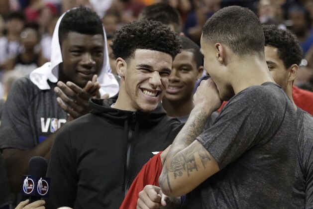 Los Angeles Lakers' Lonzo Ball, center, celebrates with teammate Kyle Kuzma, right, after the Lakers defeated the Portland Trail Blazers 110-98 in an NBA summer league championship basketball game, Monday, July 17, 2017, in Las Vegas. (AP Photo/John Locher)