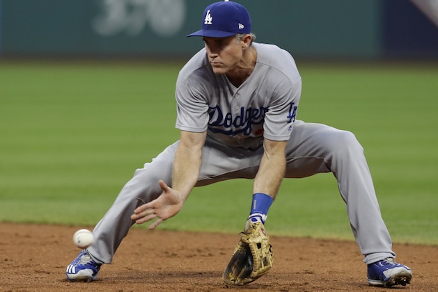 Los Angeles Dodgers' Chase Utley fields a ball hit by Cleveland Indians' Erik Gonzalez during the third inning of a baseball game, Wednesday, June 14, 2017, in Cleveland. Gonzalez was out on the play. (AP Photo/Tony Dejak)