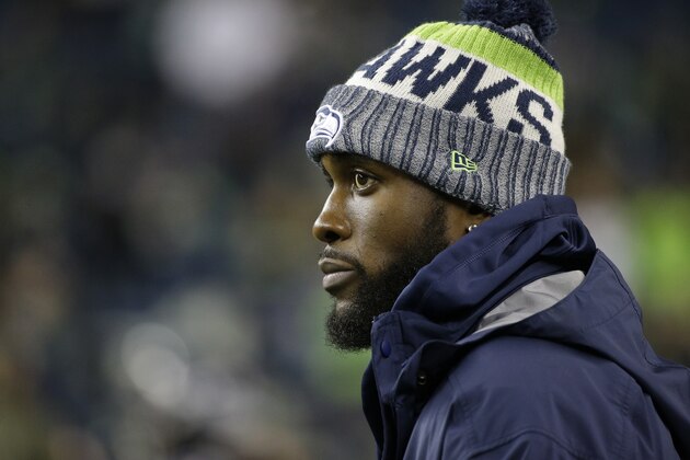 Injured Seattle Seahawks strong safety Kam Chancellor stands on the field before an NFL football game against the Atlanta Falcons, Monday, Nov. 20, 2017, in Seattle. (AP Photo/Ted S. Warren)