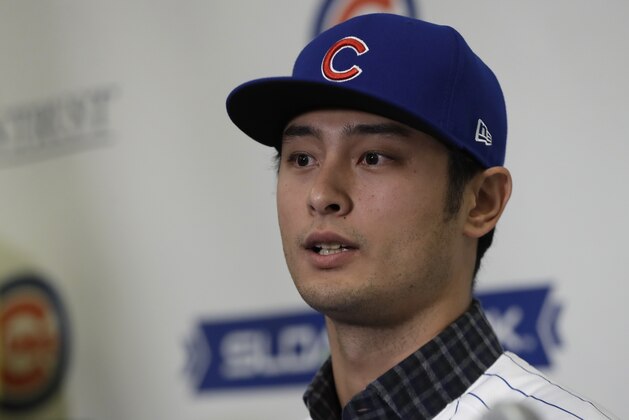 Chicago Cubs starting pitcher Yu Darvish responds during a media availability at the team's spring training baseball facility Tuesday, Feb. 13, 2018, in Mesa, Az. Darvish signed a $126 million, six-year contract over the weekend. (AP Photo/Carlos Osorio)