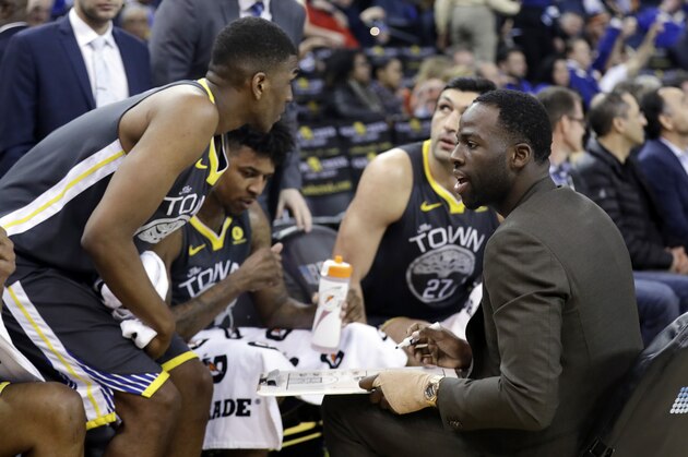 Golden State Warriors' Draymond Green, right, calls a play from the bench during the second half of an NBA basketball game against the Phoenix Suns, Monday, Feb. 12, 2018, in Oakland, Calif. (AP Photo/Marcio Jose Sanchez)