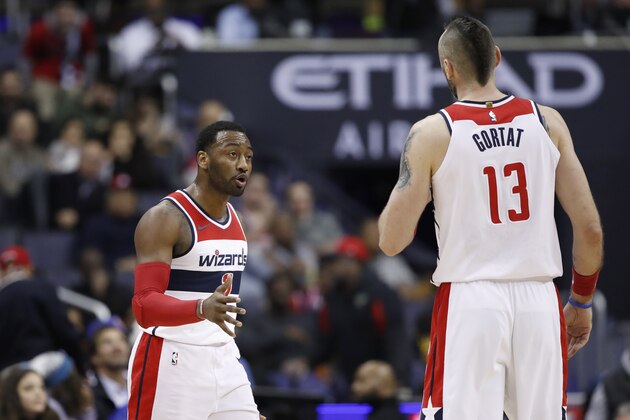Washington Wizards guard John Wall (2) talks with Washington Wizards center Marcin Gortat (13), from Poland, during the first half of an NBA basketball game against the New York Knicks, Wednesday, Jan. 3, 2018, in Washington. (AP Photo/Alex Brandon)