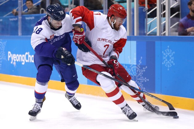 GANGNEUNG, SOUTH KOREA - FEBRUARY 14: Andrej Kudrna #18 of Slovakia competes for the pucka gainst Ivan Telegin #7 of Olympic Athlete from Russia in the second period during the Men's Ice Hockey Preliminary Round Group B game on day five of the PyeongChang 2018 Winter Olympics at Gangneung Hockey Centre on February 14, 2018 in Gangneung, South Korea.  (Photo by Maddie Meyer/Getty Images)