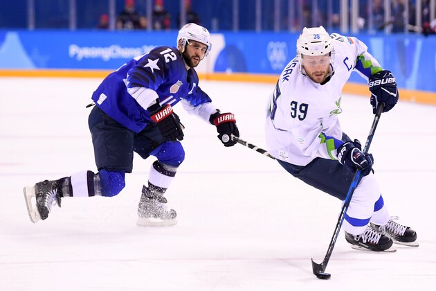 GANGNEUNG, SOUTH KOREA - FEBRUARY 14:  Jan Mursak #39 of Slovenia controls the puck against Brian Gionta #12 of the United States during the Men's Ice Hockey Preliminary Round Group B game on day five of the PyeongChang 2018 Winter Olympics at Kwandong Hockey Centre on February 14, 2018 in Gangneung, South Korea.  (Photo by Harry How/Getty Images)