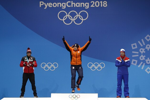 Men's 5,000 meters speedskating silver medalist Ted-Jan Bloemen, left, of Canada, and bronze medalist Sverre Lunde Pedersen, right, of Norway, applaud as gold medalist Sven Kramer, of the Netherlands, reacts during the medals ceremony at the 2018 Winter Olympics in Pyeongchang, South Korea, Monday, Feb. 12, 2018. (AP Photo/Jae C. Hong)