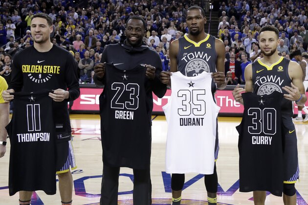 From left, Golden State Warriors' Klay Thompson, Draymond Green, Kevin Durant and Stephen Curry display their all-star jerseys before the start of an NBA basketball game against the Phoenix Suns Monday, Feb. 12, 2018, in Oakland, Calif. (AP Photo/Marcio Jose Sanchez)