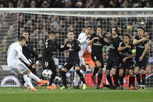 Real Madrid's Portuguese forward Cristiano Ronaldo (L) kicks the ball during the UEFA Champions League round of sixteen first leg football match Real Madrid CF against Paris Saint-Germain (PSG) at the Santiago Bernabeu stadium in Madrid on February 14, 2018.   / AFP PHOTO / GABRIEL BOUYS        (Photo credit should read GABRIEL BOUYS/AFP/Getty Images)
