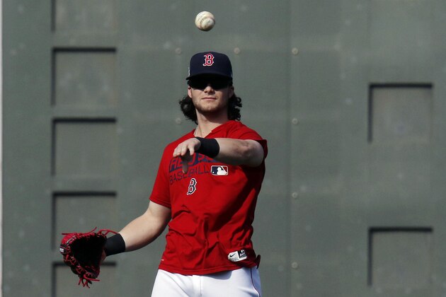 Boston Red Sox left fielder Andrew Benintendi tosses the baseball during a workout, Saturday, Oct. 7, 2017, as the team prepares for Sunday's Game 3 of baseball's American League Division Series against the Houston Astros in Boston. (AP Photo/Bill Sikes)