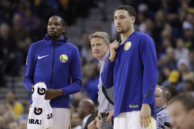 Golden State Warriors' Kevin Durant, left, head coach Steve Kerr and Klay Thompson during the second half of an NBA basketball game against the Portland Trail Blazers Monday, Dec. 11, 2017, in Oakland, Calif. (AP Photo/Marcio Jose Sanchez)