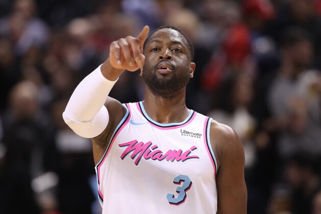 TORONTO, ON - FEBRUARY 13: Dwyane Wade #3 of the Miami Heat points during action against the Toronto Raptors at Air Canada Centre on February 13, 2018 in Toronto, Canada. NOTE TO USER: User expressly acknowledges and agrees that, by downloading and or using this photograph, User is consenting to the terms and conditions of the Getty Images License Agreement. (Photo by Tom Szczerbowski/Getty Images)