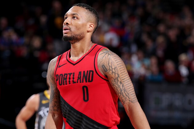 PORTLAND, OR - FEBRUARY 14: Damian Lillard #0 of the Portland Trail Blazers looks on during the game against the Golden State Warriors on February 14, 2018 at the Moda Center in Portland, Oregon. NOTE TO USER: User expressly acknowledges and agrees that, by downloading and or using this Photograph, user is consenting to the terms and conditions of the Getty Images License Agreement. Mandatory Copyright Notice: Copyright 2018 NBAE (Photo by Sam Forencich/NBAE via Getty Images)