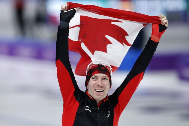 Gold medallist Ted-Jan Bloemen of Canada celebrates with the national flag after the men's 10,000 meters speedskating race at the Gangneung Oval at the 2018 Winter Olympics in Gangneung, South Korea, Thursday, Feb. 15, 2018. (AP Photo/Vadim Ghirda)
