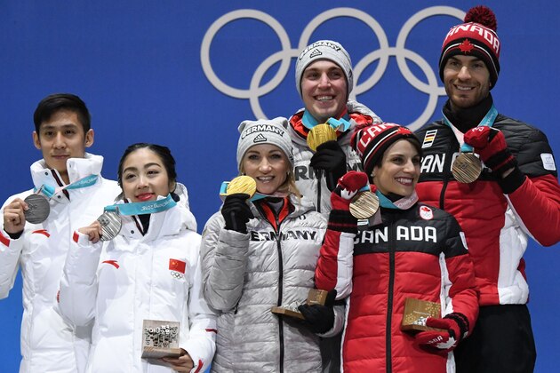 (L-R) China's silver medallists Han Cong and Sui Wenjing, Germany's gold medallists Aljona Savchenko and Bruno Massot and Canada's bronze medallists Meagan Duhamel and Eric Radford pose on the podium during the medal ceremony for the figure skating pair event at the Pyeongchang Medals Plaza during the Pyeongchang 2018 Winter Olympic Games in Pyeongchang on February 15, 2018. / AFP PHOTO / Dimitar DILKOFF        (Photo credit should read DIMITAR DILKOFF/AFP/Getty Images)