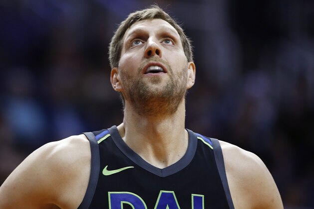 Dallas Mavericks forward Dirk Nowitzki looks at the hoop during a foul shot during the first half of an NBA basketball game against the Phoenix Suns, Wednesday, Jan. 31, 2018, in Phoenix. The Suns defeated the Mavericks 102-88. (AP Photo/Ross D. Franklin)