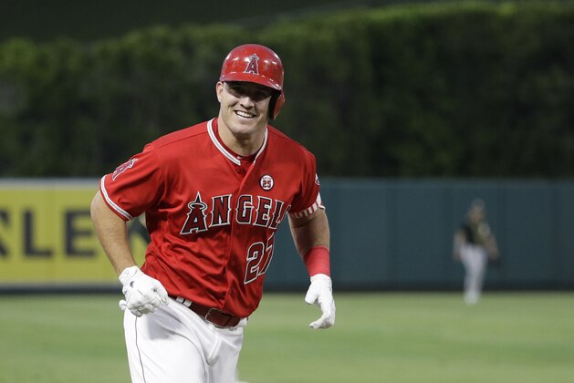 Los Angeles Angels' Mike Trout smiles as he rounds the bases after hitting a home run during the first inning of a baseball game Oakland Athletics, Wednesday, Aug. 30, 2017, in Anaheim, Calif. (AP Photo/Jae C. Hong)