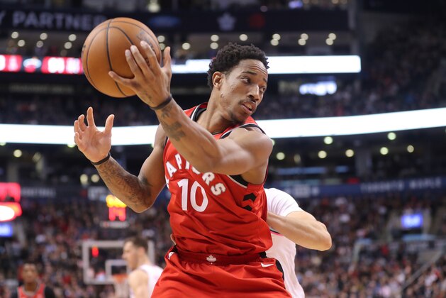 TORONTO, ON - FEBRUARY 13: DeMar DeRozan #10 of the Toronto Raptors handles a pass over his head against the Miami Heat at Air Canada Centre on February 13, 2018 in Toronto, Canada. NOTE TO USER: User expressly acknowledges and agrees that, by downloading and or using this photograph, User is consenting to the terms and conditions of the Getty Images License Agreement. (Photo by Tom Szczerbowski/Getty Images)